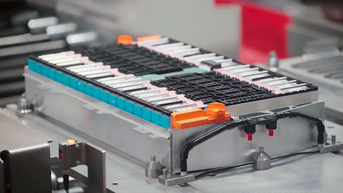 A cutting-edge battery pack is worked on in a smart manufacturing environment